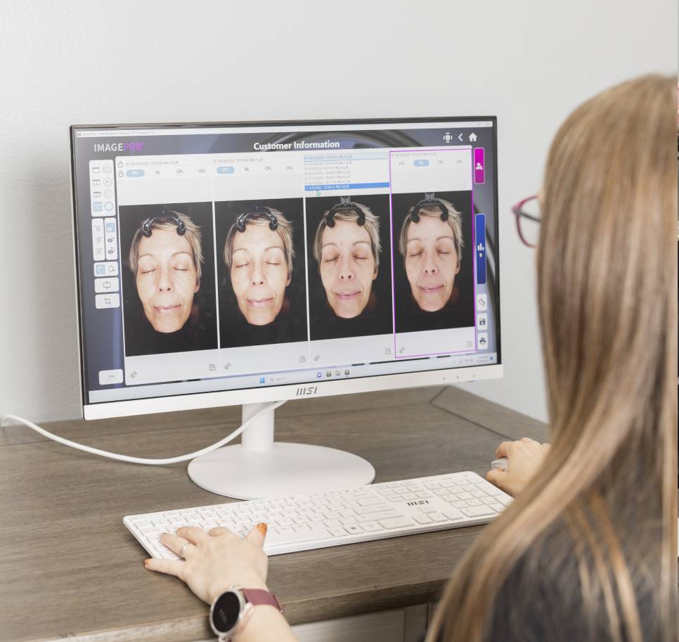 a woman standing in front of a computer